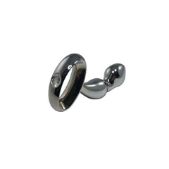Polished steel anal plug beside detached ring handle with crystal accent detail