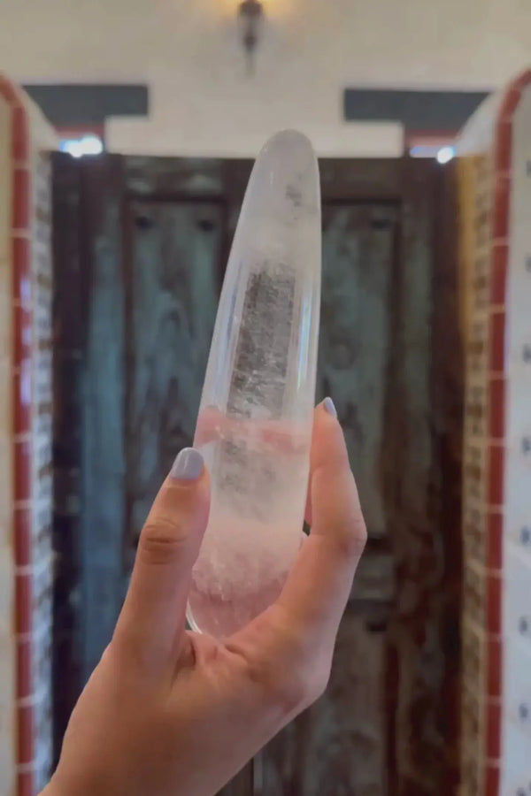 Prism Crystal Pleasure Wand held aloft in a decorated interior, illustrating its full length and weight