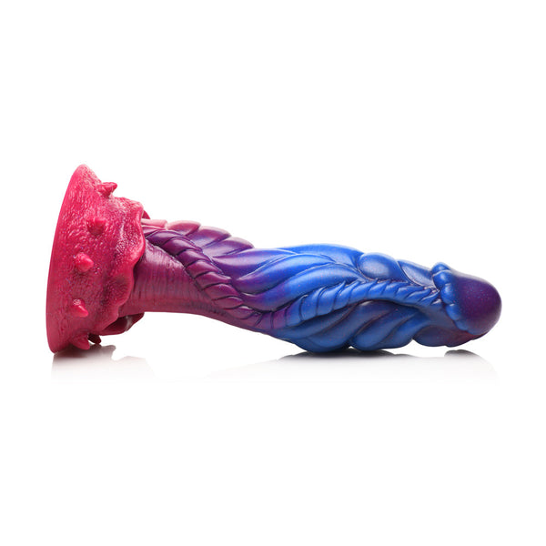 Profile view of Intruder alien dildo on white surface illustrating full curved silhouette