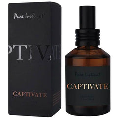 Pure Instinct Captivate amber glass spray bottle beside its matte black box