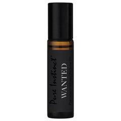 Pure Instinct Wanted amber roll-on bottle with black cap shown solo, highlighting compact 10.2 mL size