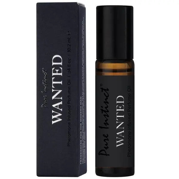 Pure Instinct Wanted pheromone roll-on perfume oil beside its matte black box, amber glass bottle
