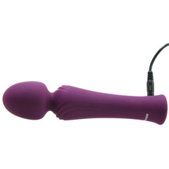 Purple Evolved wand massager lying on its side with USB charging cable attached to base