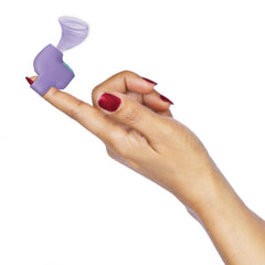 Purple finger-ring suction stimulator worn on index finger showing flared suction tip