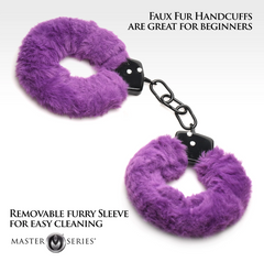 Close-up of purple furry handcuffs with text noting removable sleeve for easy cleaning