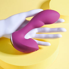 Purple Playboy Arch vibrator resting in white mannequin hand, showing ergonomic curve