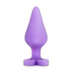 Purple silicone anal plug showing tapered tip and flower-shaped base, side profile view