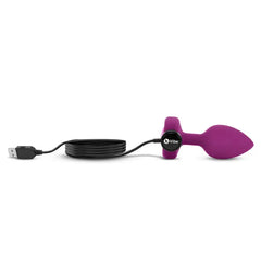 Purple silicone plug connected to magnetic USB charging cable for rechargeable battery