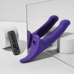 Purple Strap-On-Me Multi Orgasm Dildo L shown from rear angle beside remote and mirror