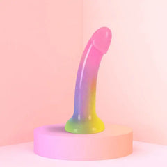 Rainbow gradient Stargazer silicone dildo displayed upright on a pastel pink platform