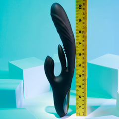 Rapid Rabbit vibrator beside a ruler showing approximately 9 inches total height on teal background