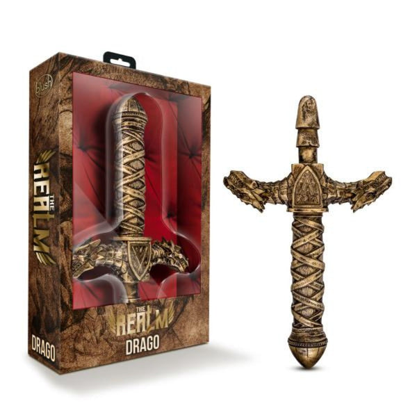 The Realm Drago dragon sword dildo in antique gold beside its fantasy-themed display box