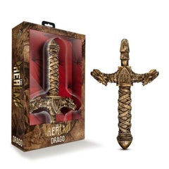 The Realm Drago dragon sword dildo in antique gold beside its fantasy-themed display box