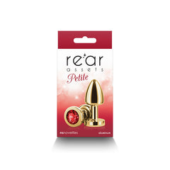 Rear Assets Petite retail packaging showing gold plug with red crystal on red and white box front