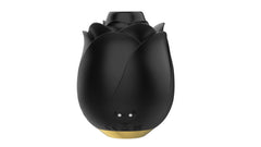 Rear view of black rose stimulator showing magnetic charging contacts and regulatory markings