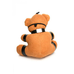 Rear view of bondage teddy bear keychain showing soft brown plush body and black strap across back