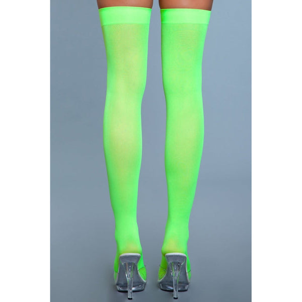 Rear view of neon green opaque thigh highs showing full length fit and semi-sheer nylon texture