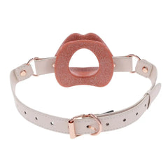 Rear view of silicone lips gag displaying rose-gold buckle closure and multiple strap holes