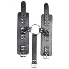 Rear view of wrist cuff panel with rivet detailing, double buckle closures, and center O-ring
