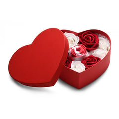 Red heart-shaped gift box with lid beside silicone rose suction stimulator nestled in roses