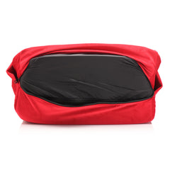 Red outer cover unzipped revealing black water-resistant inner protective cover on wedge cushion
