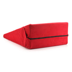 Red wedge pillow with black zipper open showing dual-layer removable cover construction underneath