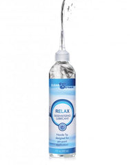 Relax Desensitizing Lube squeeze bottle with extended nozzle tip dispensing clear water-based formula