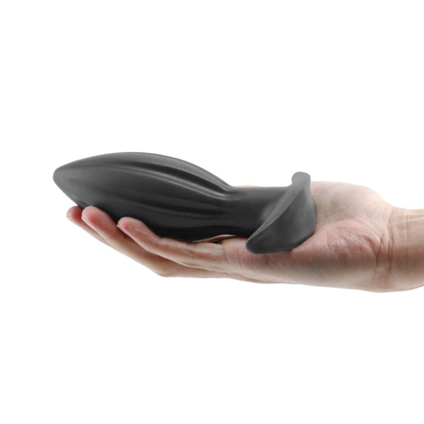 Renegade Bomba medium black silicone anal plug held in an open palm showing tapered shape