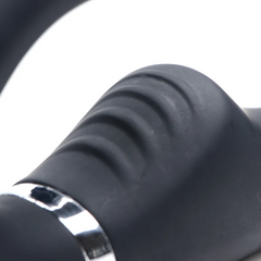 Close-up of ridged textured grip section and chrome accent ring on black silicone strap-on