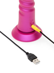 ROMP Jiggle connected to yellow magnetic USB charging cable at suction cup base