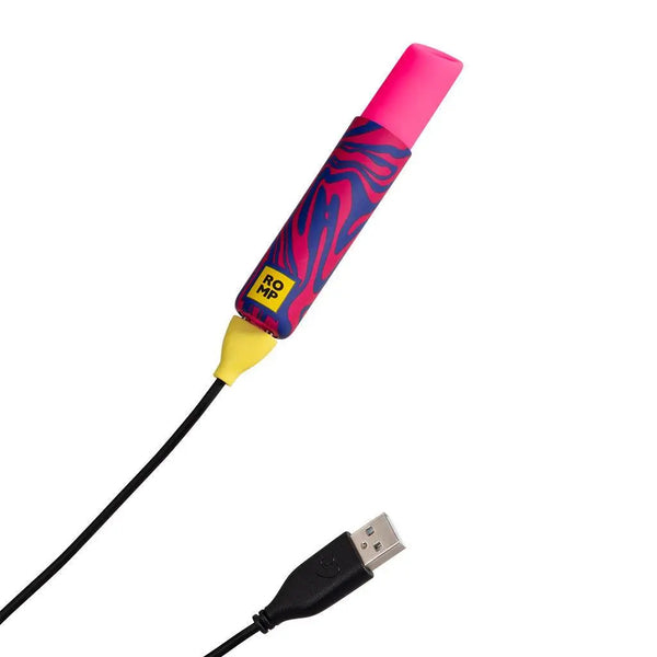 Romp Lipstick vibe connected to USB magnetic charging cable, zebra-print body
