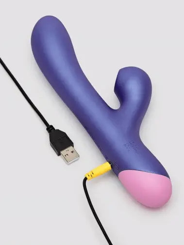 ROMP Pulse rabbit vibrator lying flat with USB magnetic charging cable connected at base