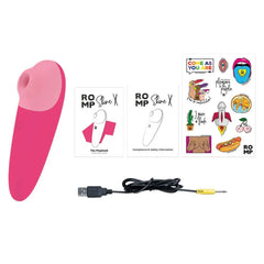 Romp Shine X stimulator shown with USB charging cable, user guides, and sticker sheet