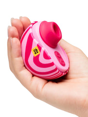 ROMP Spin clitoral stimulator resting in a palm, showing compact handheld size