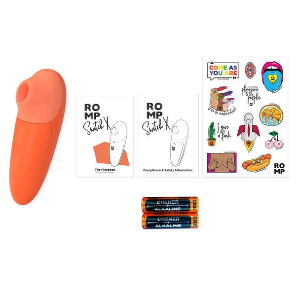 ROMP Switch X unboxed contents including device, playbook, safety guide, sticker sheet, and batteries