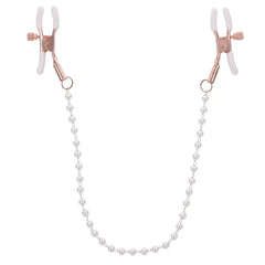 Close-up of rose gold adjustable nipple clamps connected by a lustrous faux-pearl beaded chain