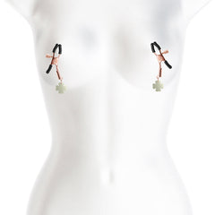 Rose gold adjustable nipple clamps with green clover pendants shown on a white mannequin torso
