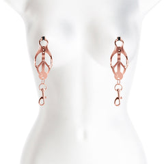 Rose gold clover nipple clamps shown on mannequin torso, illustrating fit and hanging bolt snap detail