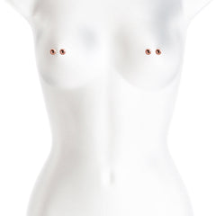 Rose gold magnetic ball nipple clamps shown positioned on a white mannequin torso