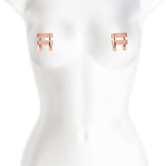 Rose gold nipple clamps displayed on mannequin torso, illustrating fit and placement