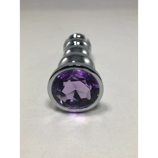 Close-up of the round purple gemstone base on the Pink Elephant Bud Bullet plug