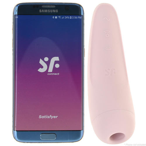 Satisfyer Curvy 2+ pink air-pulse stimulator beside a Samsung smartphone showing the SF Connect app