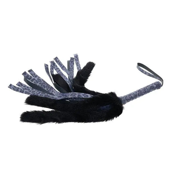 Sex & Mischief flogger laid flat, displaying full length of fur and patterned ribbon falls