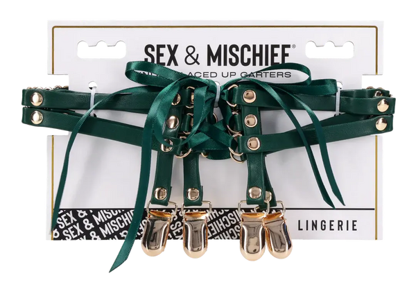 Sex & Mischief Indica Laced Up Garters in emerald green with gold-tone clips on packaging