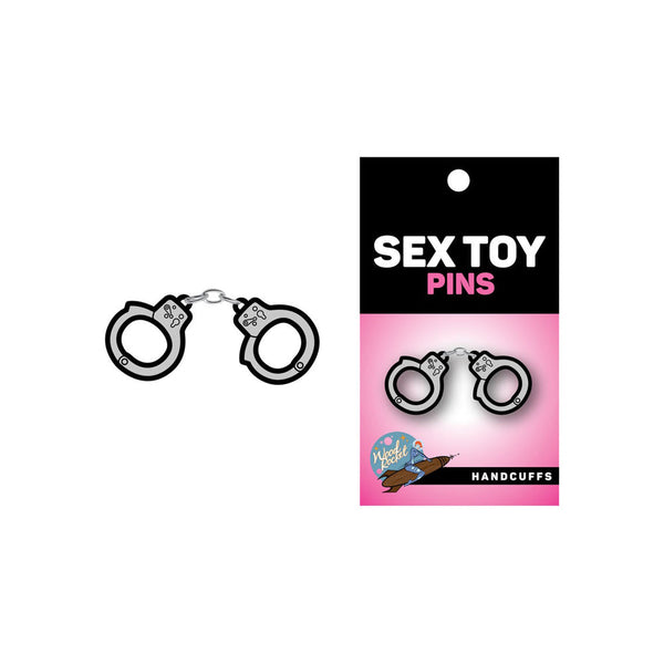 Sex Toy Pins handcuffs enamel pin shown beside its black and pink retail card packaging