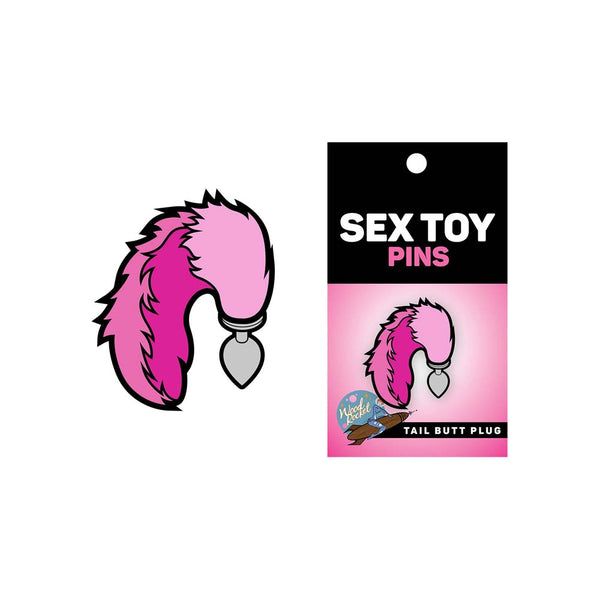 Sex Toy Pins tail butt plug enamel pin shown beside its black and pink retail card packaging