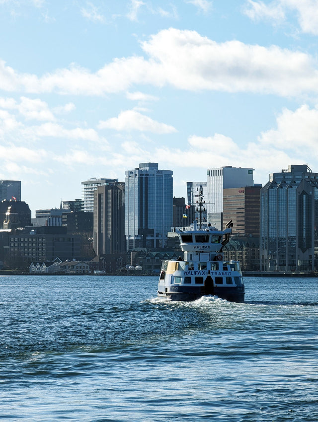 A Halifax Transit ferry crossing the harbour in front of the Halifax skyline