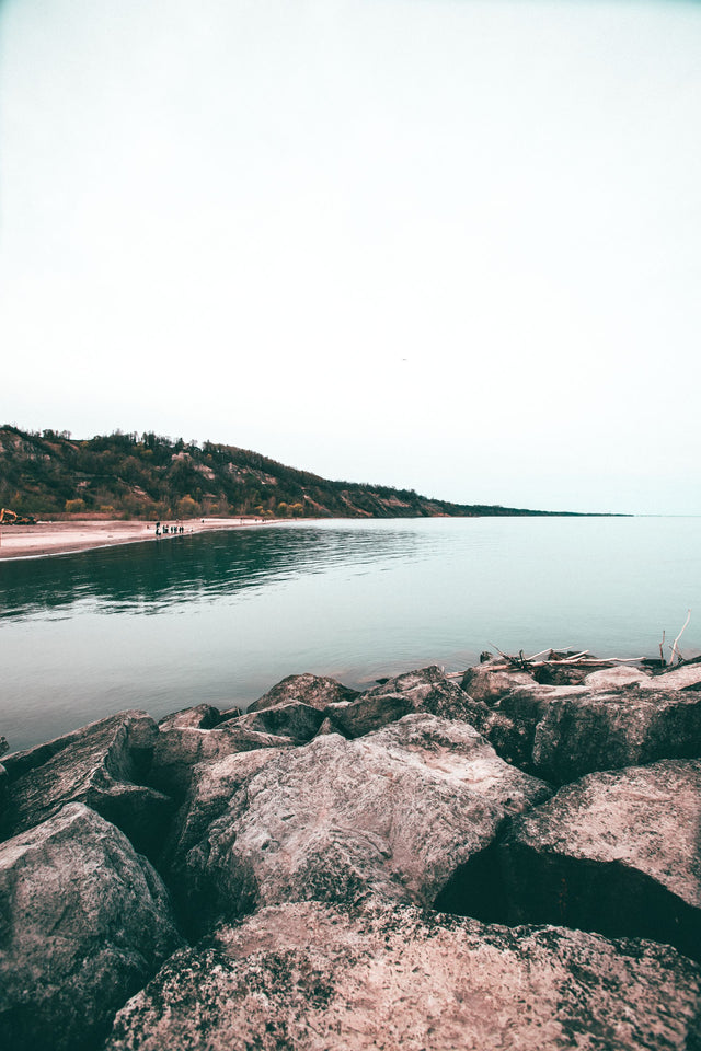 Rocks and a small island along the Lake Ontario shoreline