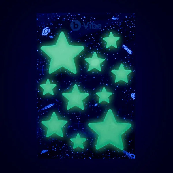 Sheet of glow-in-the-dark star stickers from b-Vibe Asstronaut set glowing against dark background