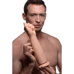 Shirtless man holding the MS Fisto Clenched Fist Dildo upright to show full arm-length scale